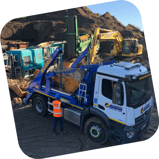 A Norris truck exchanges a skip at a commercial construction project